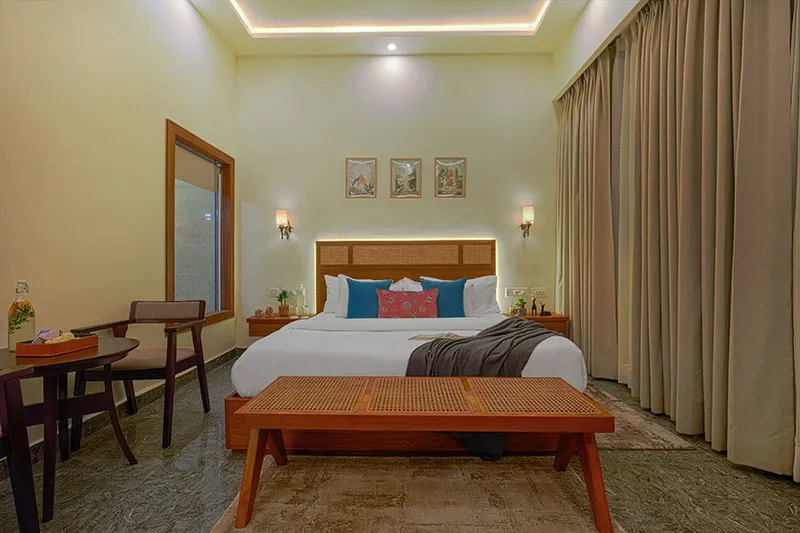 King bed with framed wall art in a Manovan Resort room